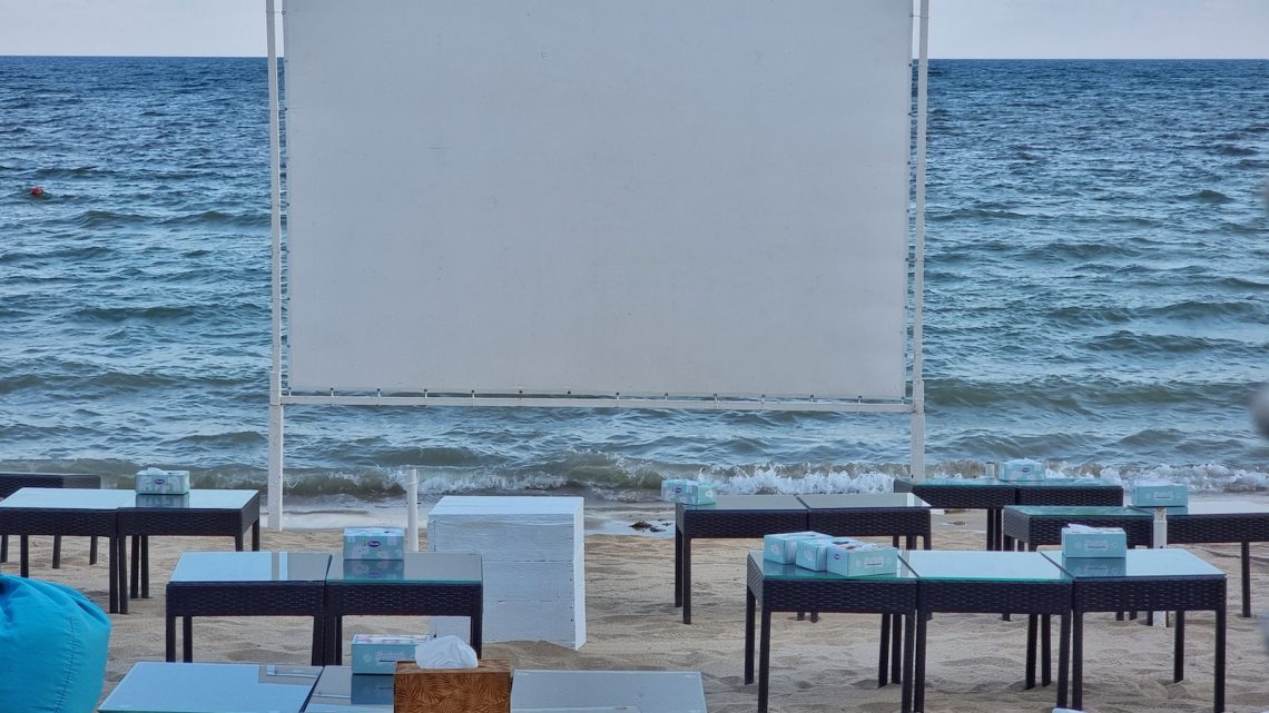 tables and chairs on a beach